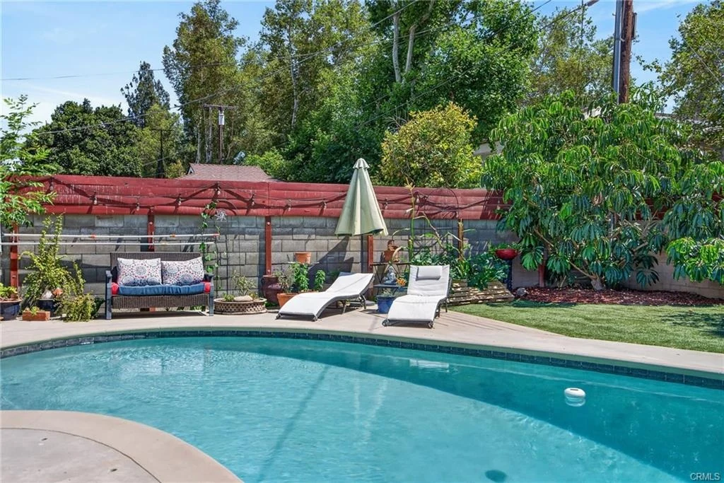 Private backyard swimming pool in daylight