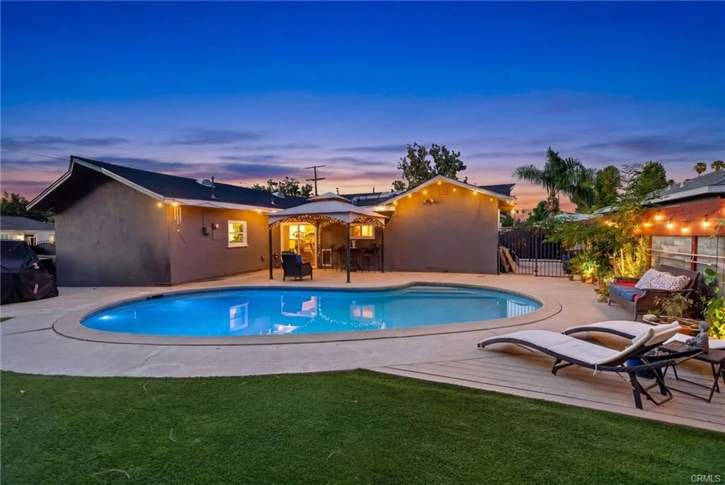 Euclid Court backyard pool glowing at dusk